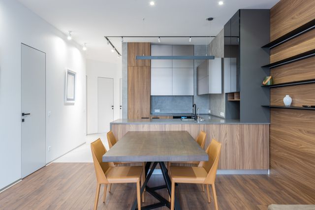 a contemporary kitchen and dining area with wooden finishes