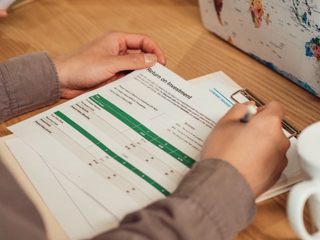 a person analyzing a return on investment report