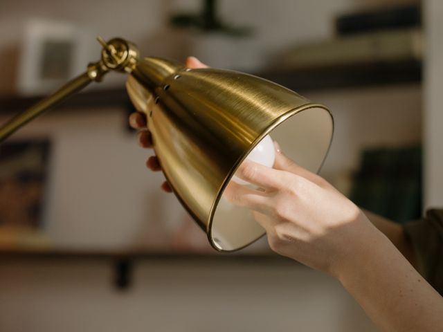 hand adjusting a lightbulb