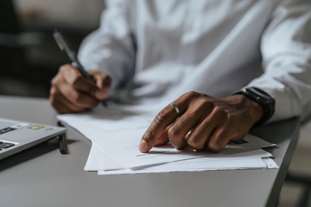 person at a desk reviewing documents