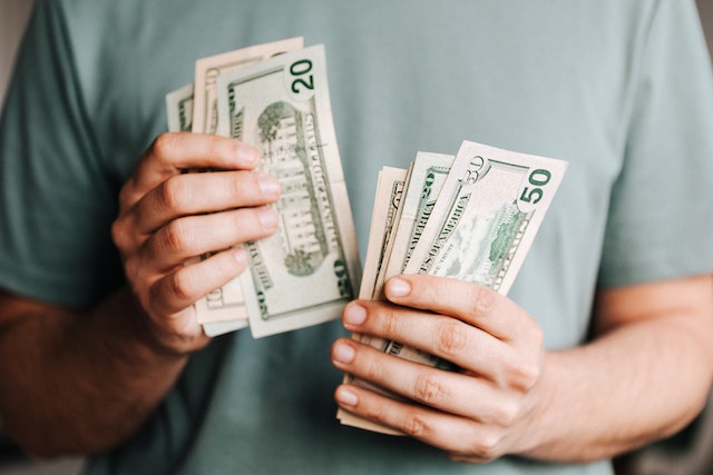 person-counting-dollar-bills